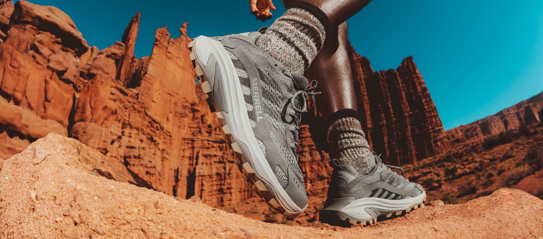 Close-up of Merrell Moab Speed 2 hiking shoes on red desert rock